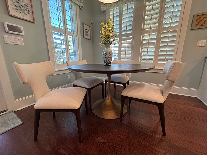 Contemporary interior design by KDC Interiors — modern pedestal dining table with sculptural chairs in a Charleston breakfast nook