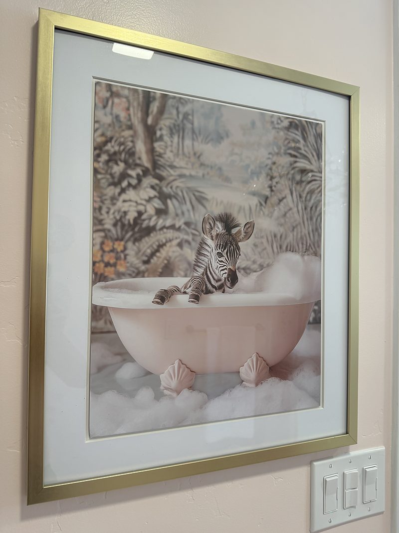 Framed artwork of a zebra in a bathtub, by KDC Interiors