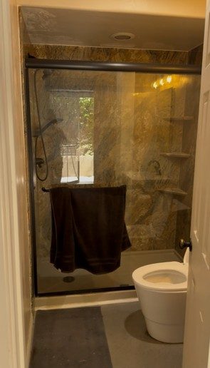 Before: the dark, windowless shower with dated tile