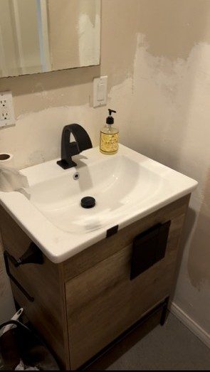 Before: the builder-grade vanity and unfinished walls