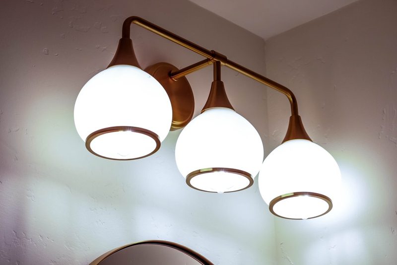 Champagne bronze globe vanity light, by KDC Interiors