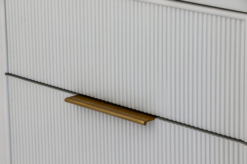 Reeded vanity front with a brass pull, by KDC Interiors