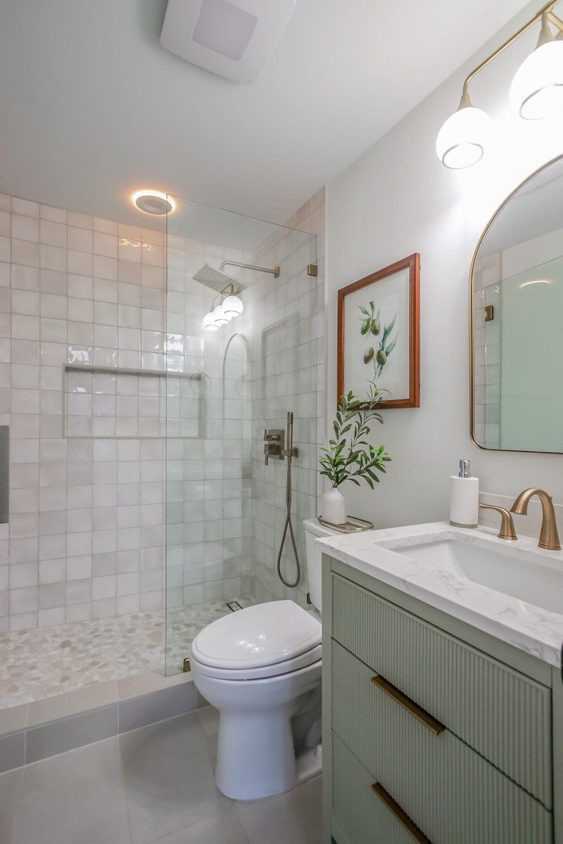 Zellige tile shower with a pebble tile floor, by KDC Interiors