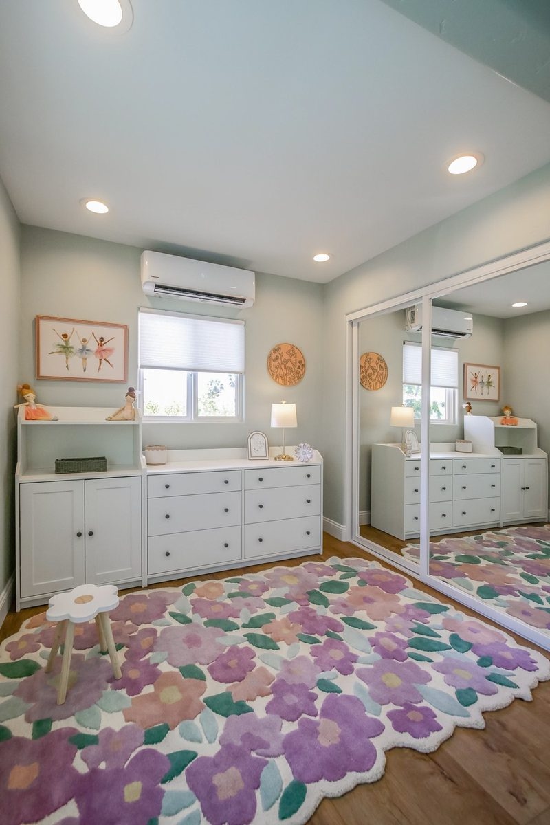 White dresser and floral rug in the guest suite, by KDC Interiors