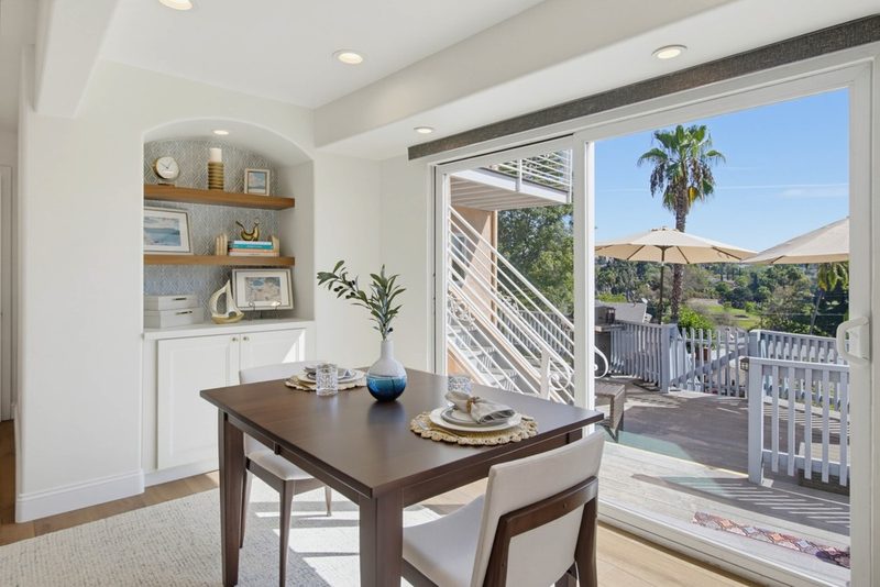 Dining table beside the sliding door with a view to the deck, by KDC Interiors