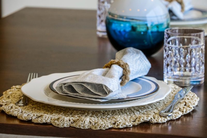 Woven place setting on the dining table, by KDC Interiors