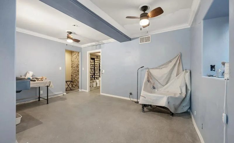 Before: the open pottery workspace with a bare concrete floor, reachable only from an exterior rear entrance