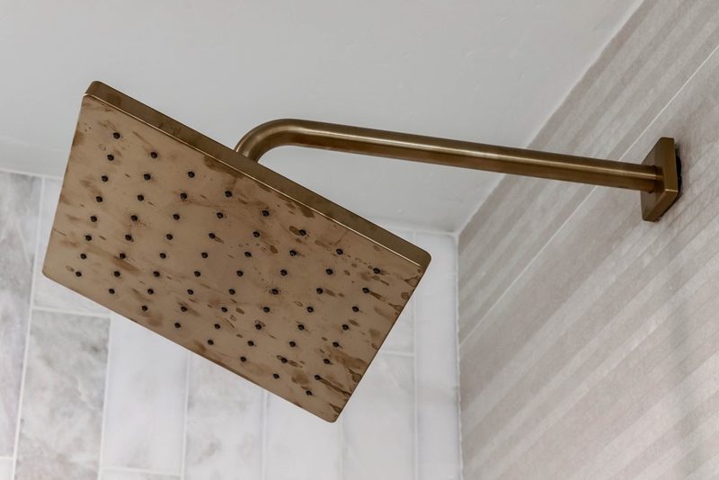 Brass rain shower head, by KDC Interiors